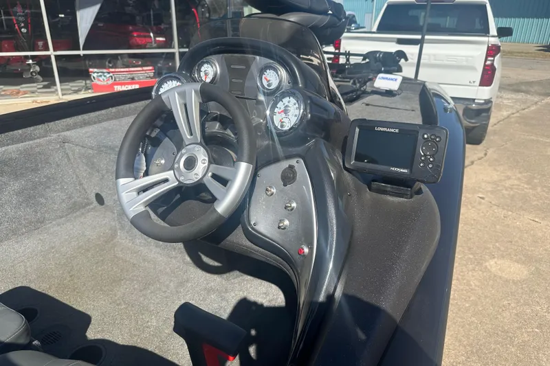 Slide: The Image of 2024 Tracker Pro Team 175 TXW boat dashboard with steering wheel and Lowrance fishfinder. - 12