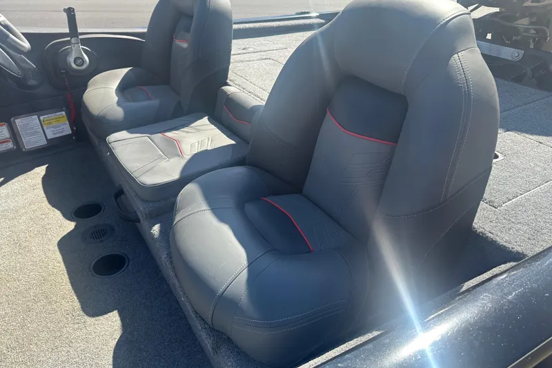 Slide: The Image of 2024 Tracker Pro Team 175 TXW boat interior with gray seats and red accents. - 5