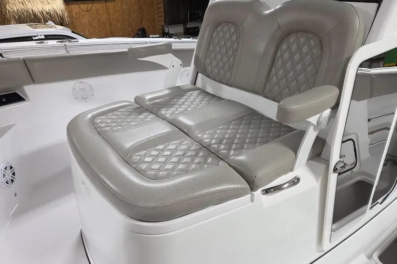 Slide: The Image of 2022 Sportsman Open 322 Center Console boat seating with diamond-stitched upholstery. - 11