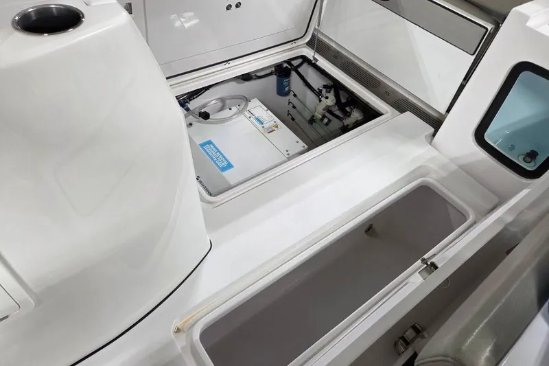 Slide: The Image of 2022 Sportsman Open 322 Center Console interior with storage compartments and equipment. - 14