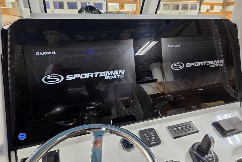 Slide: The Image of 2022 Sportsman Open 322 Center Console dashboard with Garmin displays and steering wheel. - 17