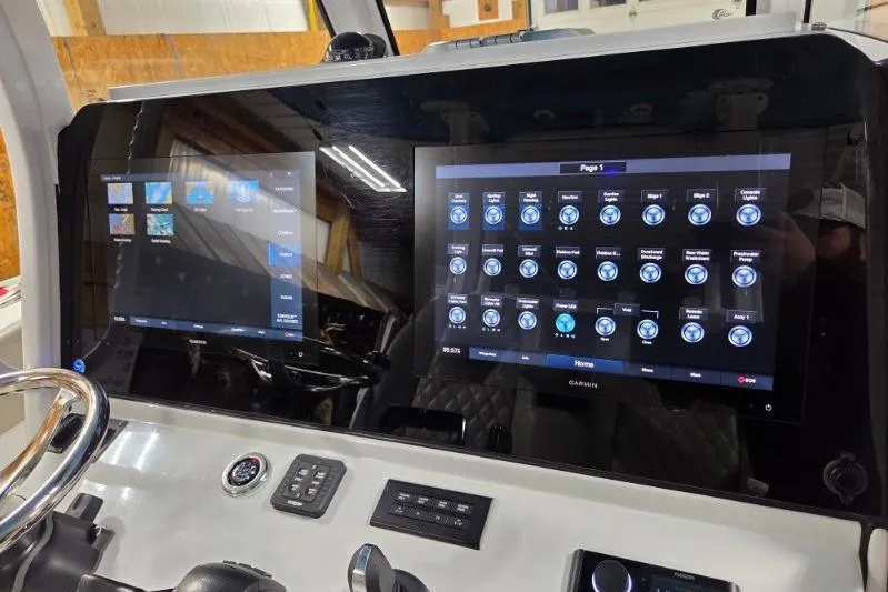 Slide: The Image of 2022 Sportsman Open 322 Center Console dashboard with dual Garmin displays. - 18