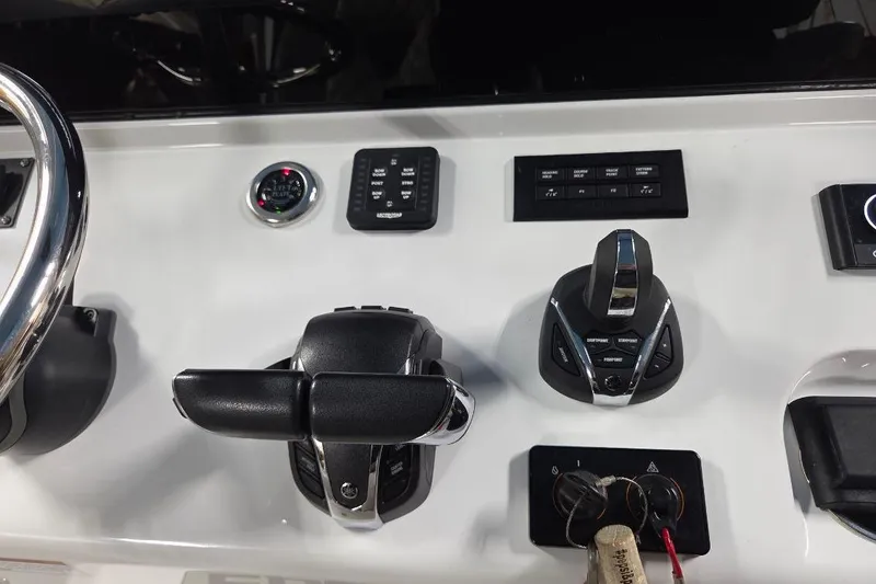 Slide: The Image of Control panel of 2022 Sportsman Open 322 Center Console boat with steering and throttle. - 19