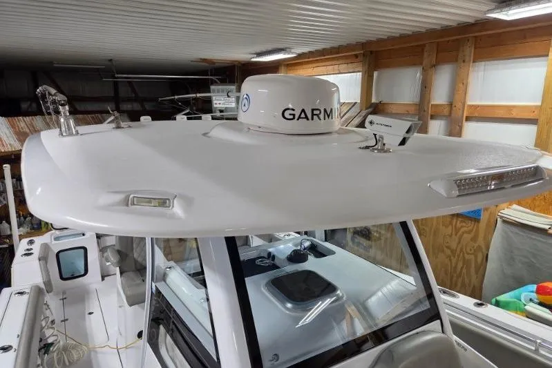 Slide: The Image of 2022 Sportsman Open 322 Center Console boat with Garmin radar in a garage. - 23