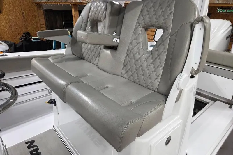 Slide: The Image of 2022 Sportsman Open 322 Center Console boat with luxurious gray seating and armrests. - 26