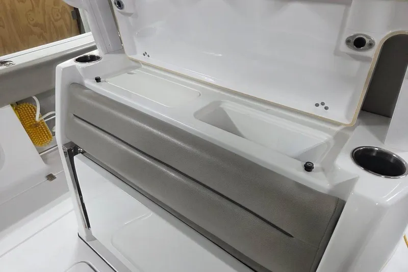 Slide: The Image of 2022 Sportsman Open 322 Center Console interior with storage and cup holders. - 28