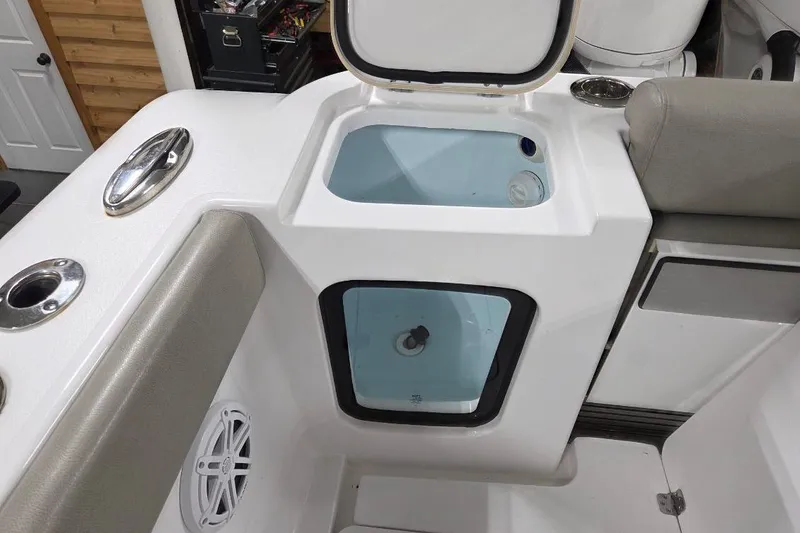 Slide: The Image of 2022 Sportsman Open 322 Center Console boat interior with storage compartment and seating. - 31