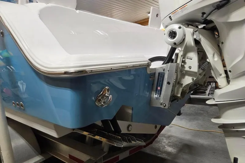 Slide: The Image of 2022 Sportsman Open 322 Center Console boat with outboard motor, blue and white design. - 4