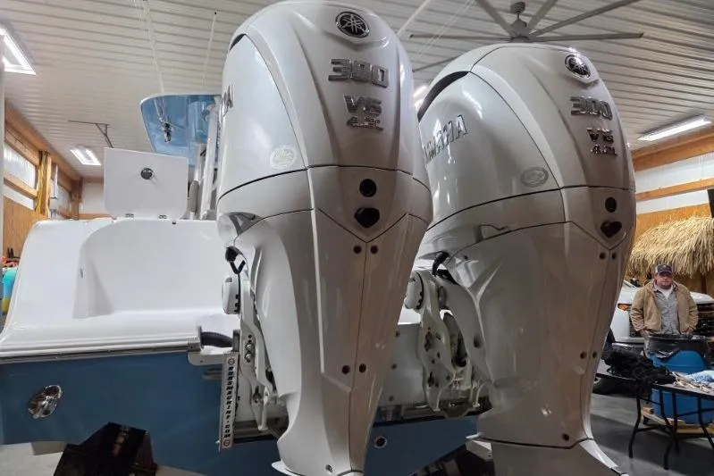 Slide: The Image of 2022 Sportsman Open 322 Center Console with twin Yamaha 300 engines in a garage. - 5