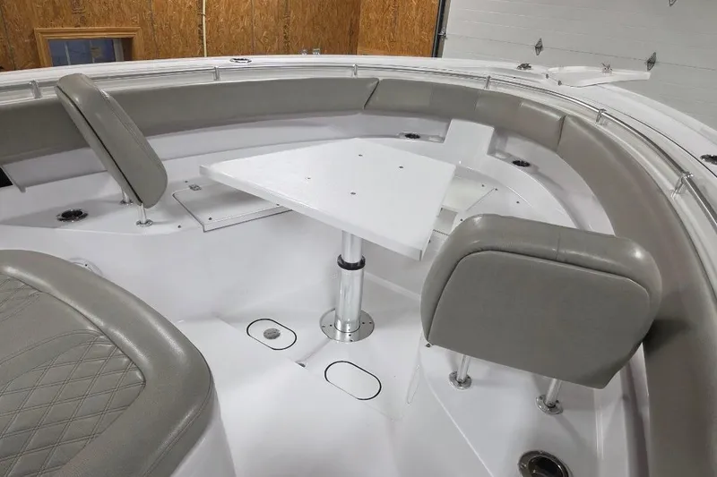 Slide: The Image of 2022 Sportsman Open 322 Center Console boat interior with seating and table. - 6