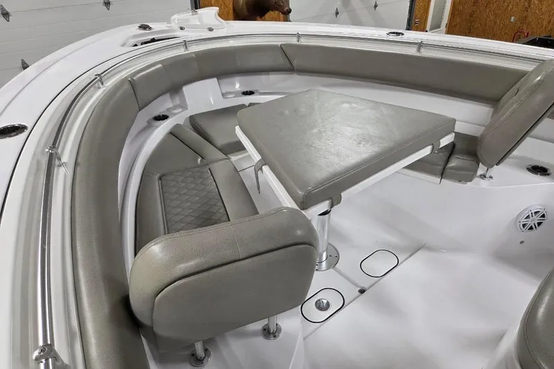 Slide: The Image of 2022 Sportsman Open 322 Center Console boat with cushioned seating and table. - 8
