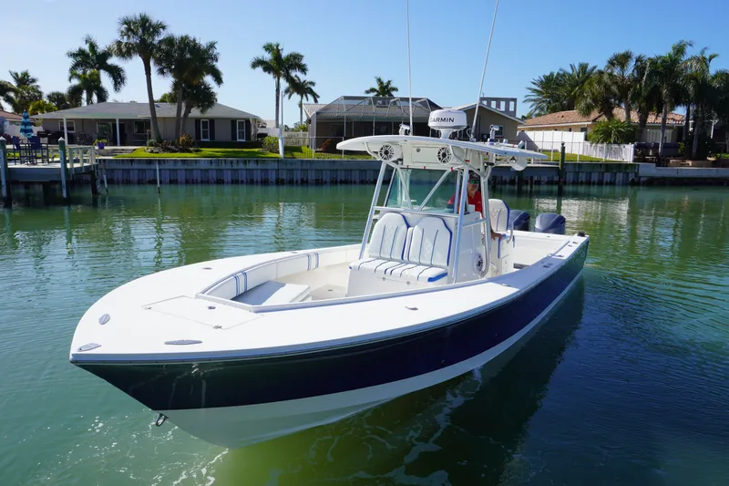 Slide: The Image of 2005 Regulator 32 boat with forward seating on calm water. - 1