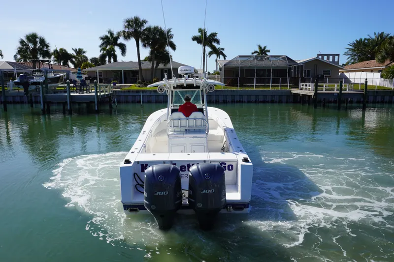 Slide: The Image of 2005 Regulator 32 boat on calm water with palm trees in the background. - 15