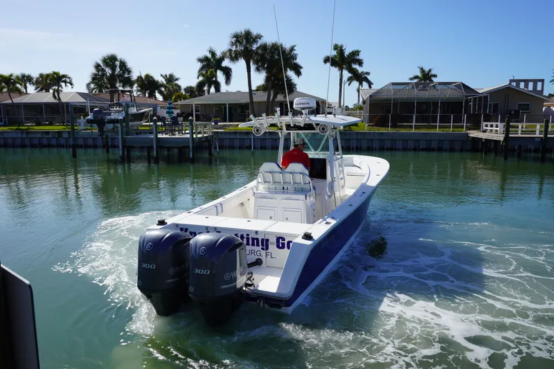 Slide: The Image of 2005 Regulator 32 boat cruising in sunny canal. - 16