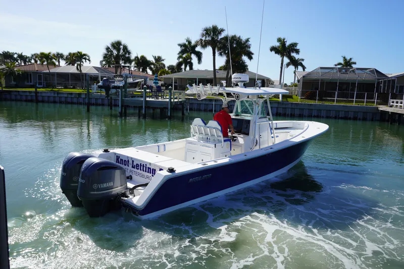 Slide: The Image of 2005 Regulator 32 boat on calm water with palm trees in the background. - 17