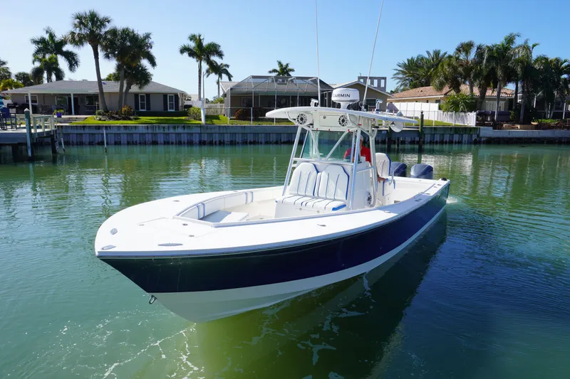 Slide: The Image of 2005 Regulator 32 boat anchored on calm water. - 2