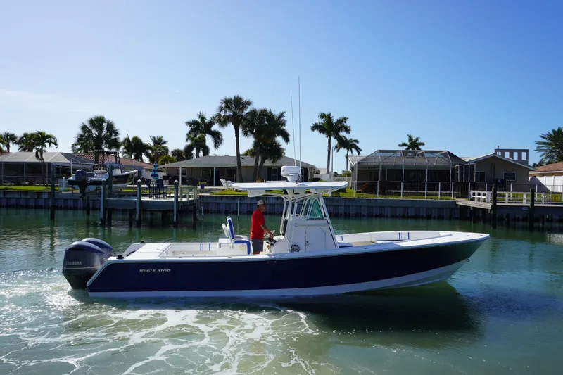 Slide: The Image of 2005 Regulator 32 boat on calm water with palm trees. - 21
