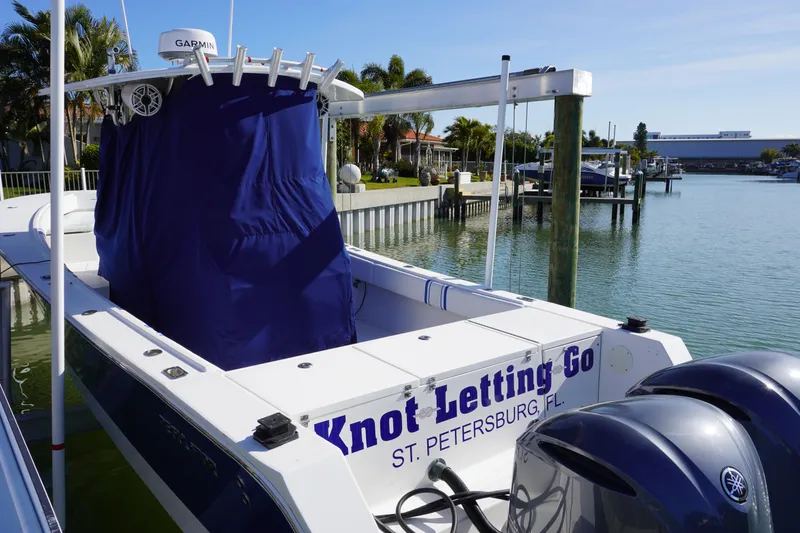 Slide: The Image of Regulator 32 boat with blue cover docked in St. Petersburg, FL. - 27
