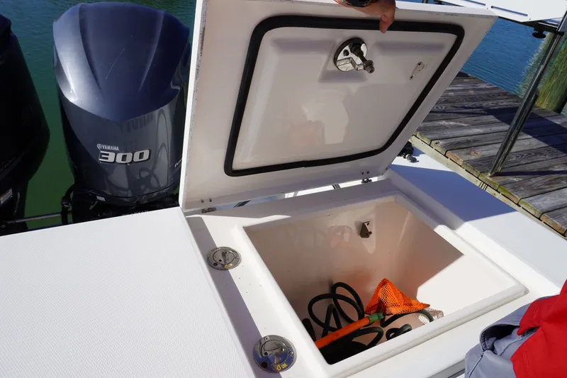 Slide: The Image of Regulator 32 boat with open storage compartment and Yamaha 300 engine. - 35