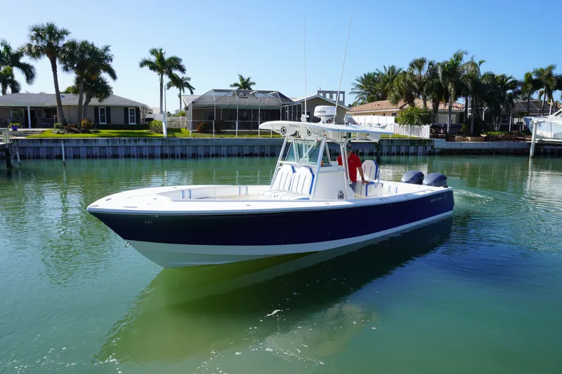 Slide: The Image of 2005 Regulator 32 Forward Seating boat on calm water. - 5