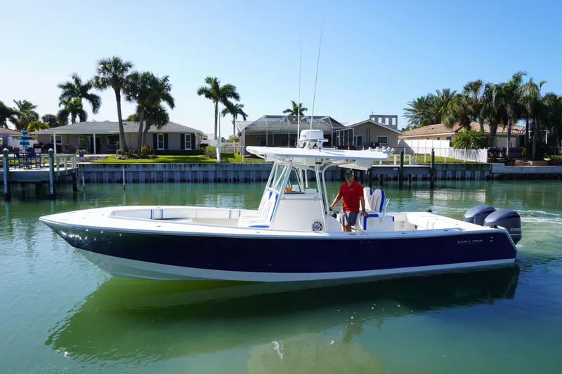 Slide: The Image of 2005 Regulator 32 boat on calm water with palm trees. - 8