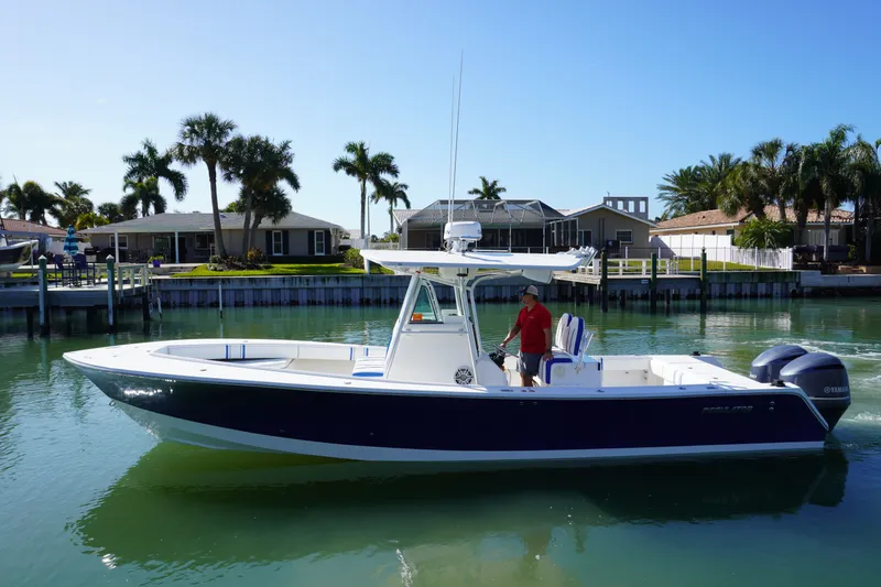 Slide: The Image of 2005 Regulator 32 boat on calm water with palm trees in background. - 9