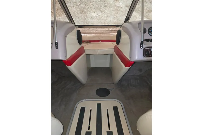 Slide: The Image of Interior of a 1997 Bryant 182 Limited boat with red and beige seating. - 3