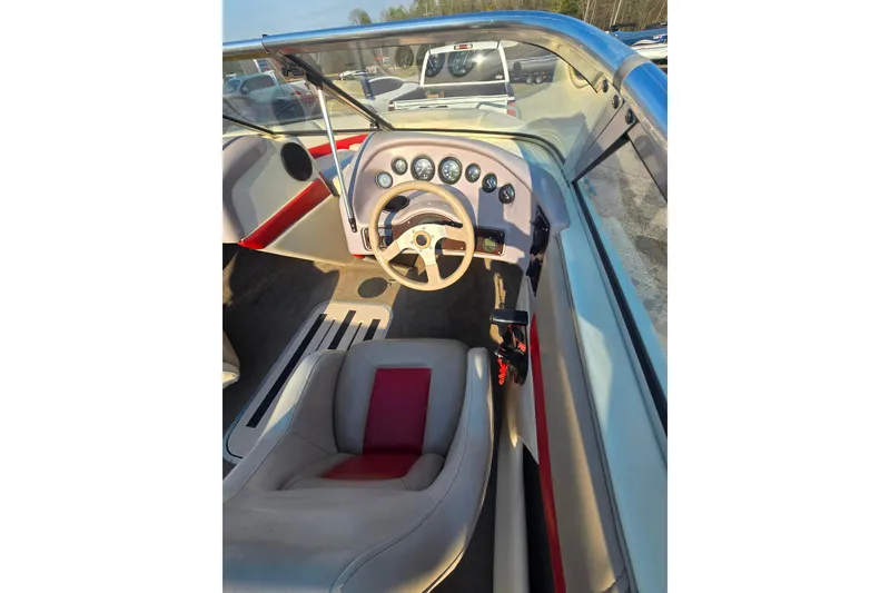 Slide: The Image of 1997 Bryant 182 boat interior with steering wheel and dashboard gauges. - 5