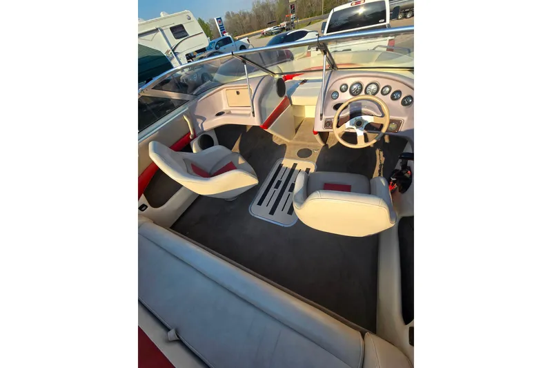 Slide: The Image of Interior of a 1997 Bryant 182 boat with beige and red seating. - 9