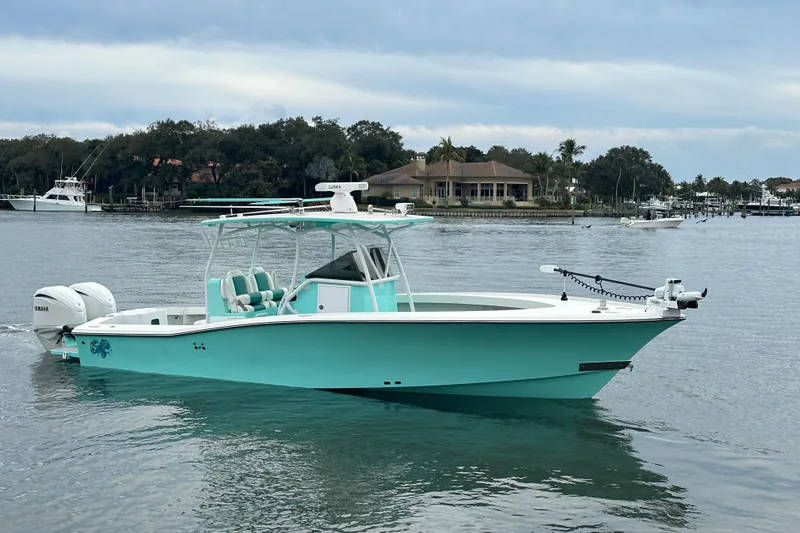 Slide: The Image of 2026 Stanley White Fishmaster boat on calm water, featuring a sleek turquoise design. - 0