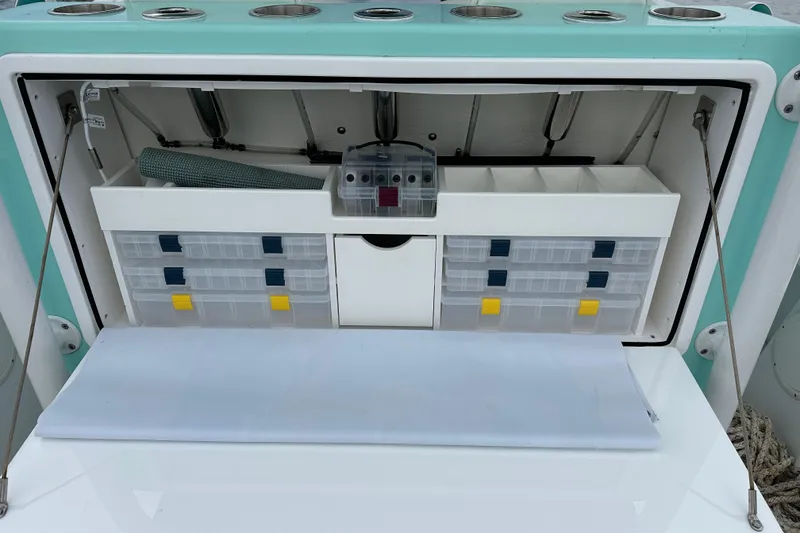 Slide: The Image of Stanley White Fishmaster 2026 boat storage compartment with organized tackle boxes and accessories. - 11