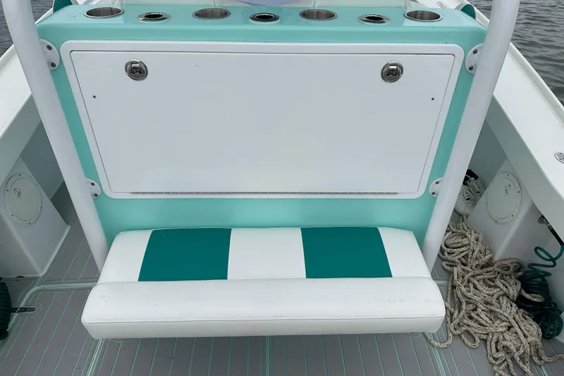 Slide: The Image of Stanley White Fishmaster 2026 boat seat with teal and white design, featuring storage and cup holders. - 12
