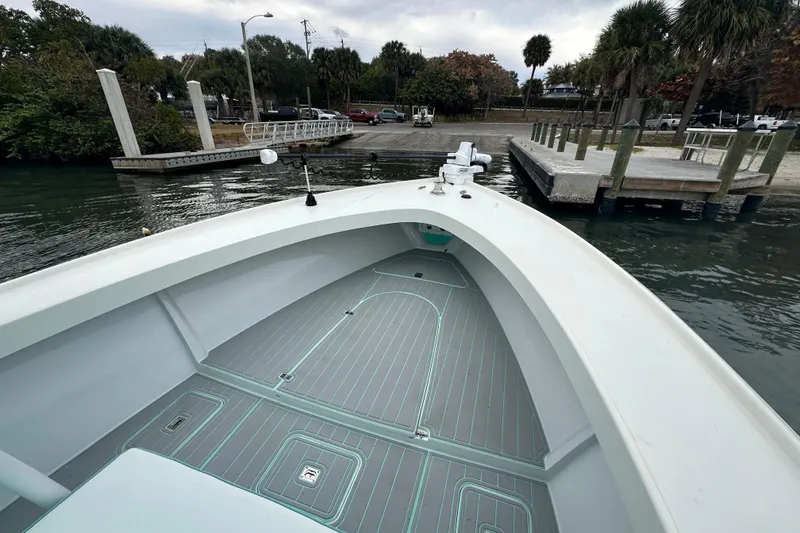 Slide: The Image of 2026 Stanley White Fishmaster boat docked at a marina with palm trees. - 15