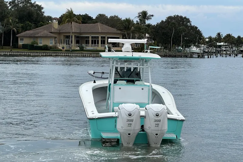 Slide: The Image of 2026 Stanley White Fishmaster boat with dual engines on a serene waterfront. - 2