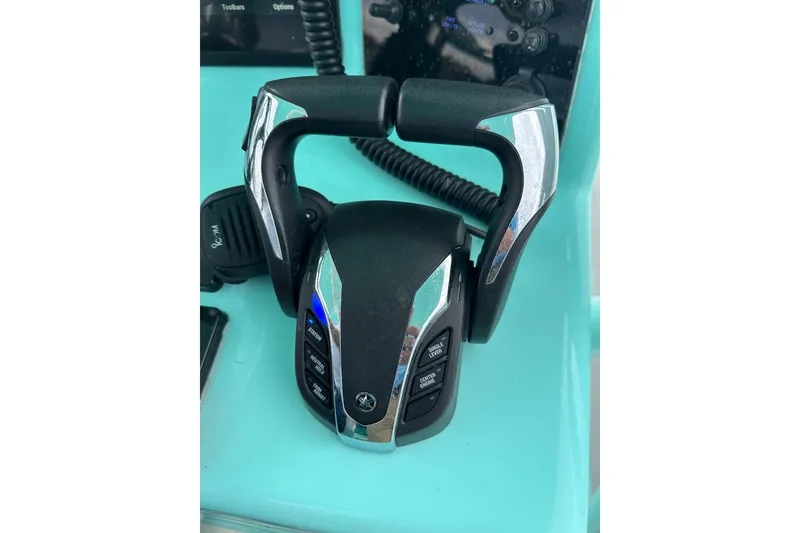 Slide: The Image of 2026 Stanley White Fishmaster boat throttle control on turquoise dashboard. - 4