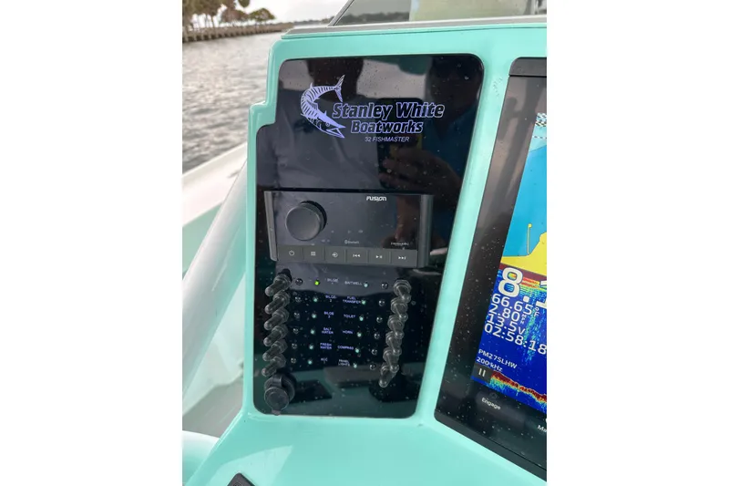 Slide: The Image of Control panel of 2026 Stanley White Fishmaster boat with navigation and audio systems. - 6