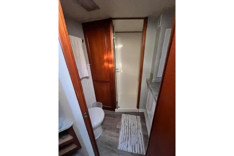 Slide: The Image of Bathroom interior of a 1995 Post 50 Convertible yacht with wooden cabinetry and shower. - 21