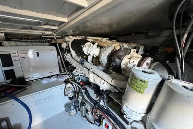 Slide: The Image of Engine room of a 1995 Post 50 Convertible boat, showcasing machinery and components. - 23