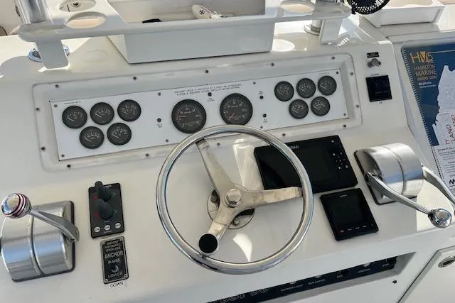 Slide: The Image of Control panel of a 1995 Post 50 Convertible boat with steering wheel and gauges. - 7
