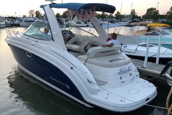 Slide: The Image of 2008 Chaparral Signature 270 boat docked at marina with passengers relaxing. - 6