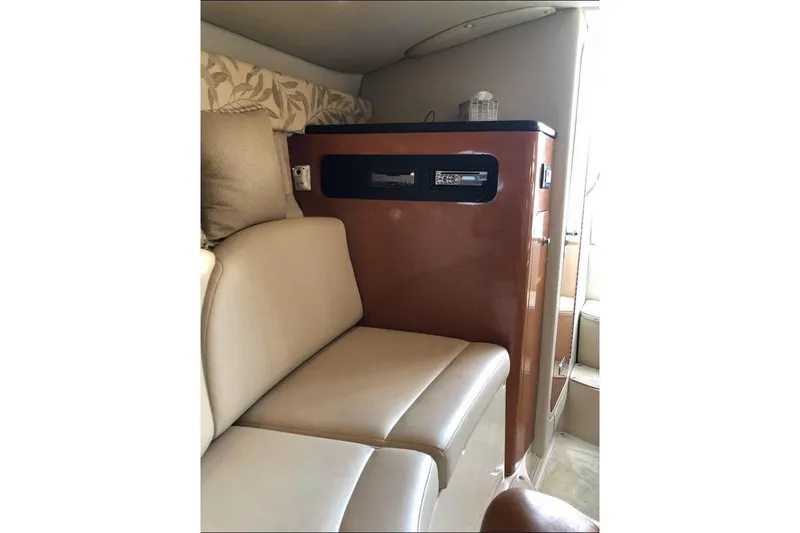 Slide: The Image of 2008 Chaparral Signature 270 interior with beige seating and wooden cabinetry. - 7