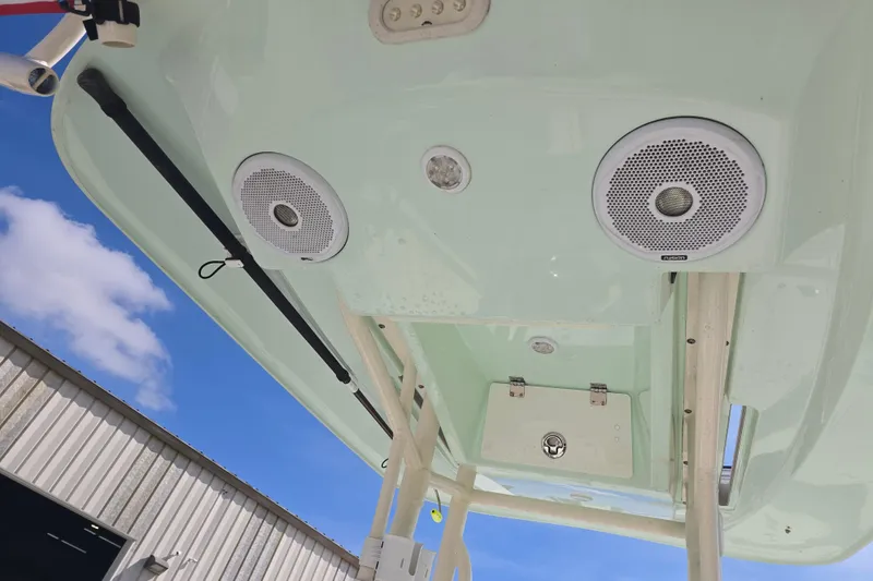 Slide: The Image of 2016 Pathfinder 2600 HPS boat speakers and storage compartment under clear blue sky. - 16