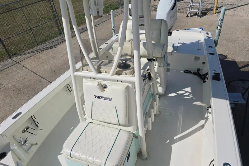 Slide: The Image of 2016 Pathfinder 2600 HPS boat interior with seating and fishing rod holders. - 18