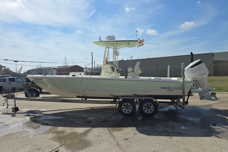 Slide: The Image of 2016 Pathfinder 2600 HPS boat on trailer under clear blue sky. - 2