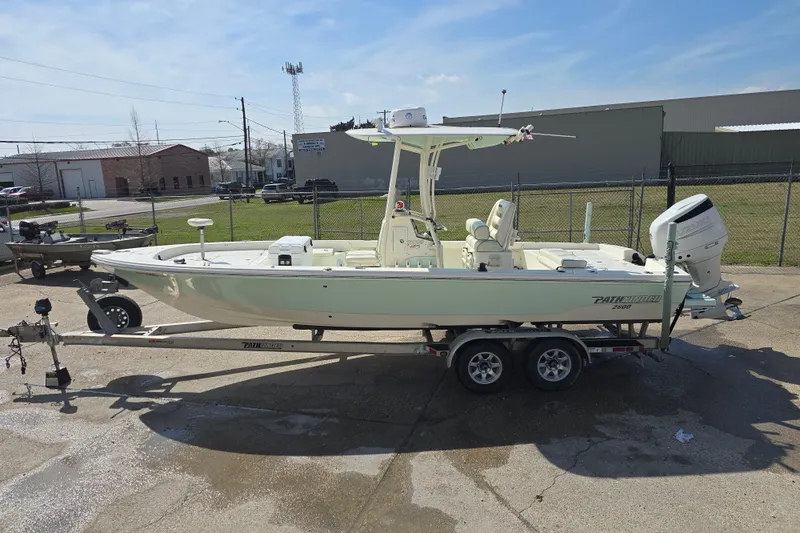 Slide: The Image of 2016 Pathfinder 2600 HPS boat on trailer, parked outdoors under clear sky. - 3