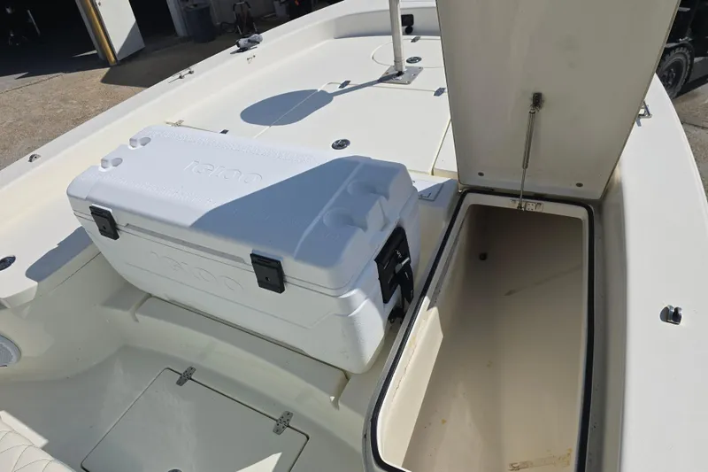 Slide: The Image of 2016 Pathfinder 2600 HPS boat interior with open storage compartment and cooler. - 6