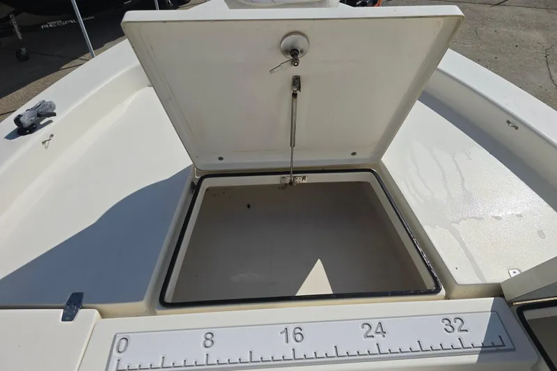 Slide: The Image of Open storage compartment on a 2016 Pathfinder 2600 HPS boat, with measuring scale. - 8