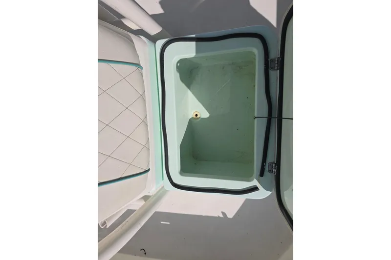 Slide: The Image of Open storage compartment on 2016 Pathfinder 2600 HPS boat, featuring a clean interior. - 9