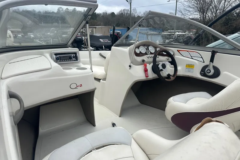 Slide: The Image of 2005 Tahoe Q4 Sport boat interior with steering wheel and dashboard controls. - 13