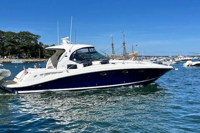 Slide: The Image of 2005 Sea Ray 420 Sundancer yacht cruising on a sunny day in a scenic harbor. - 1